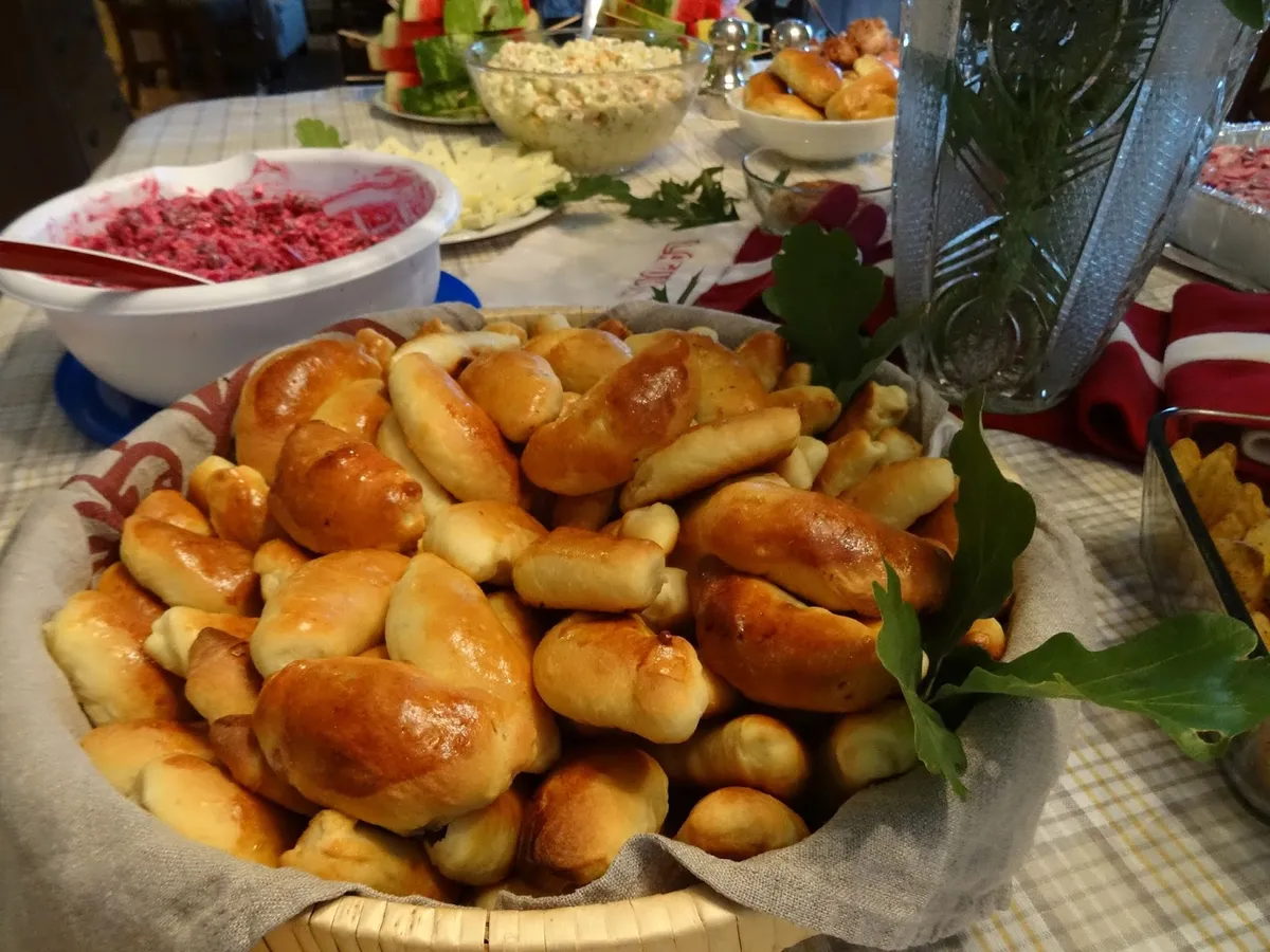 Jāņi festival foods — caraway cheese, dark bread, and beer laid out for the Latvian midsummer feast