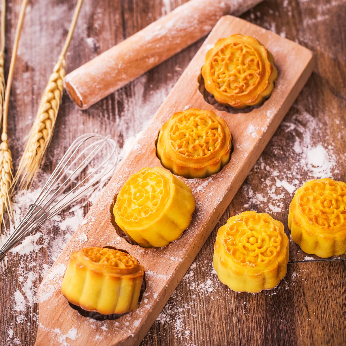 Making mooncakes by hand — pressing dough and lotus paste into wooden molds at home