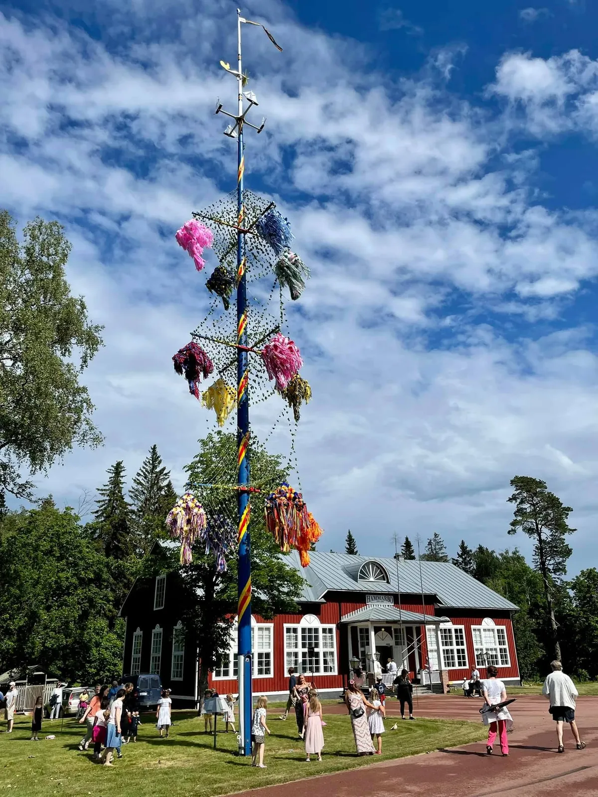 Flower-decorated Swedish midsommarstång raised for midsummer — the iconic symbol of the season